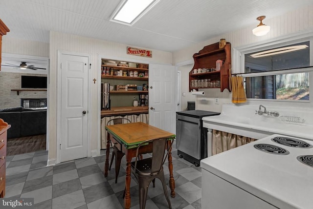 kitchen with range with electric cooktop, a fireplace, light countertops, fridge, and open shelves