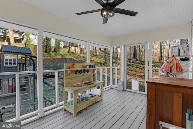 sunroom with plenty of natural light and a ceiling fan