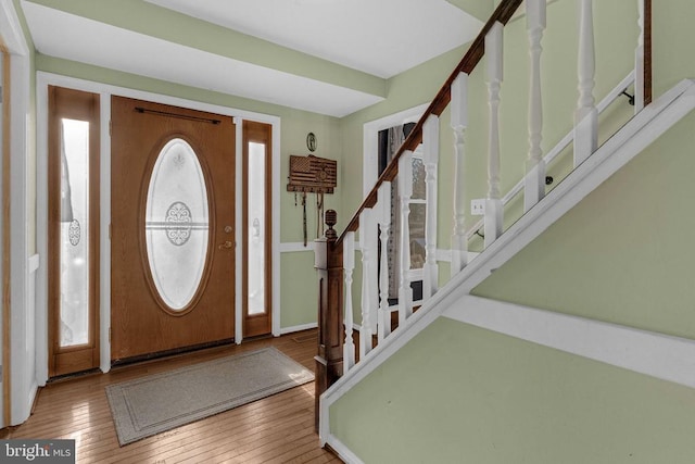 foyer entrance with wood-type flooring and stairs