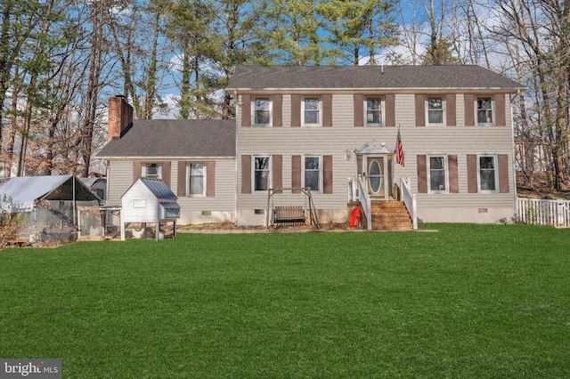 colonial home featuring crawl space, a chimney, a front lawn, and roof with shingles