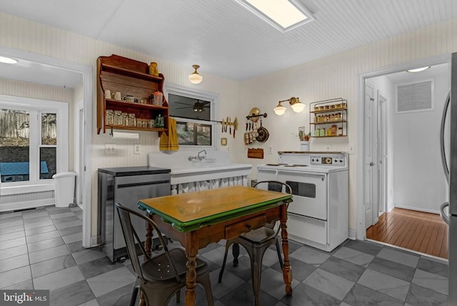 kitchen with visible vents, a sink, open shelves, and white range with electric cooktop