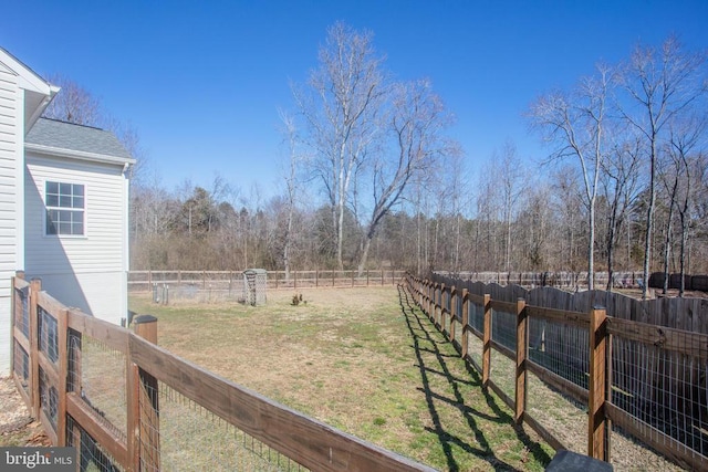 view of yard featuring a rural view and a fenced backyard