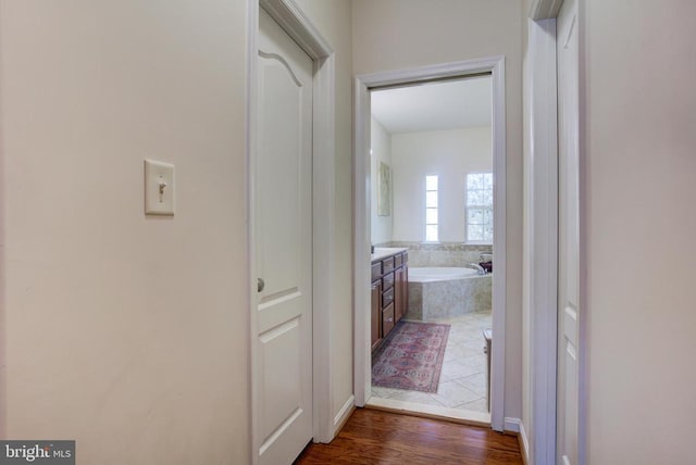 corridor featuring dark wood finished floors