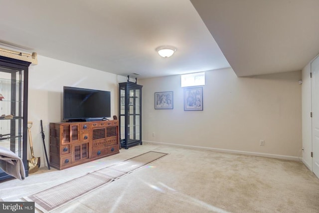 carpeted living area featuring baseboards