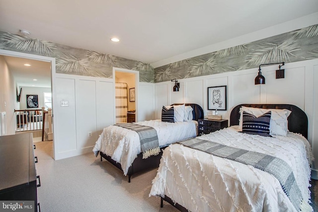 bedroom with wallpapered walls, recessed lighting, and a decorative wall