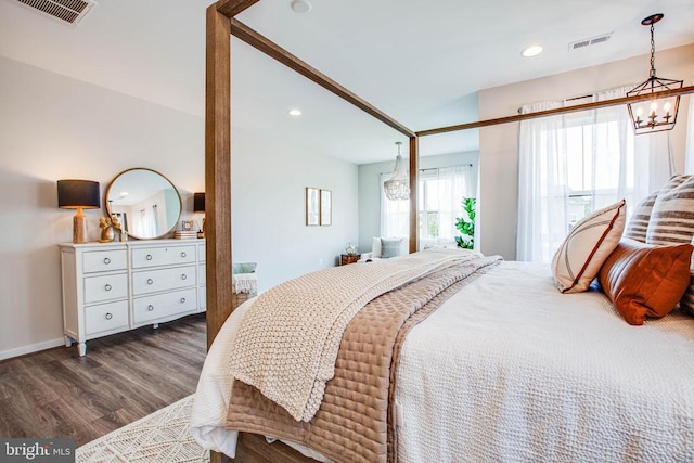 bedroom featuring recessed lighting, visible vents, a notable chandelier, and wood finished floors