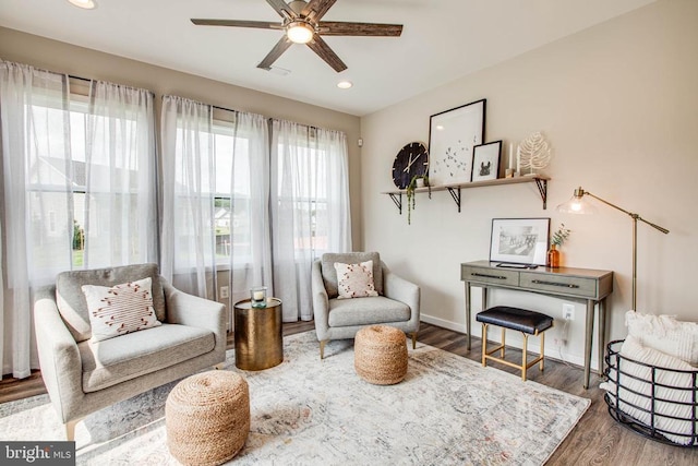 living area featuring recessed lighting, ceiling fan, baseboards, and wood finished floors