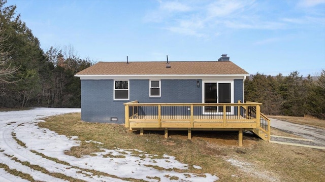 snow covered property featuring a wooden deck