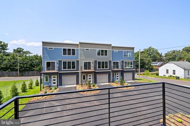 back of property featuring a balcony