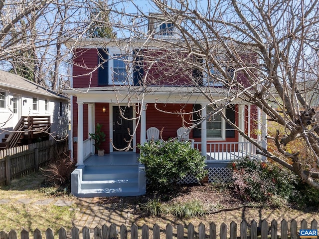 view of front facade featuring a porch and fence