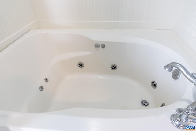 full bathroom featuring a whirlpool tub