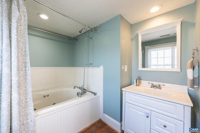 full bathroom featuring visible vents, wood finished floors, recessed lighting, a tub with jets, and vanity