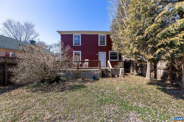 back of house featuring fence private yard and a deck