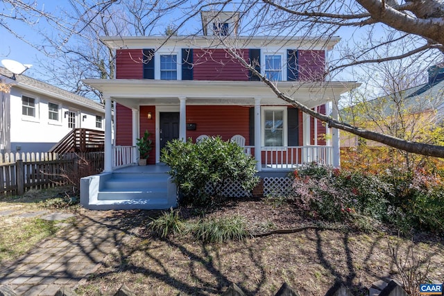 view of front of home featuring fence and covered porch