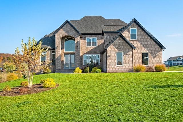 view of front of house featuring a front yard and french doors