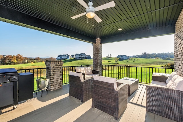 view of patio / terrace featuring an outdoor living space, a wooden deck, and ceiling fan