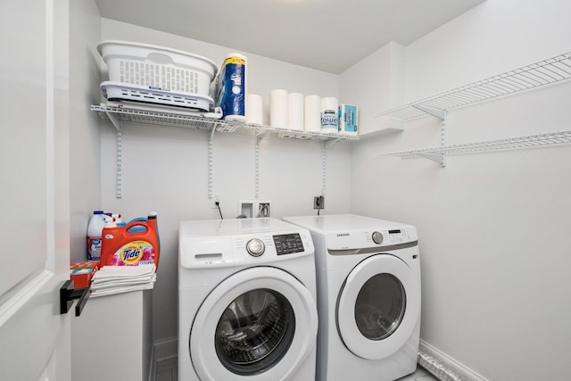 clothes washing area featuring washer and dryer