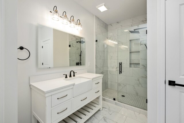 bathroom with vanity and a shower with shower door