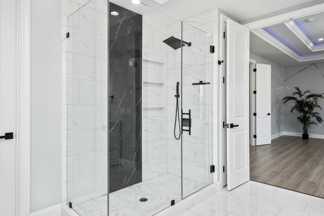 bathroom with ornamental molding and walk in shower