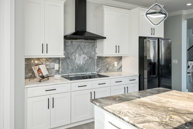 kitchen featuring white cabinets, black electric stovetop, stainless steel fridge with ice dispenser, crown molding, and wall chimney exhaust hood