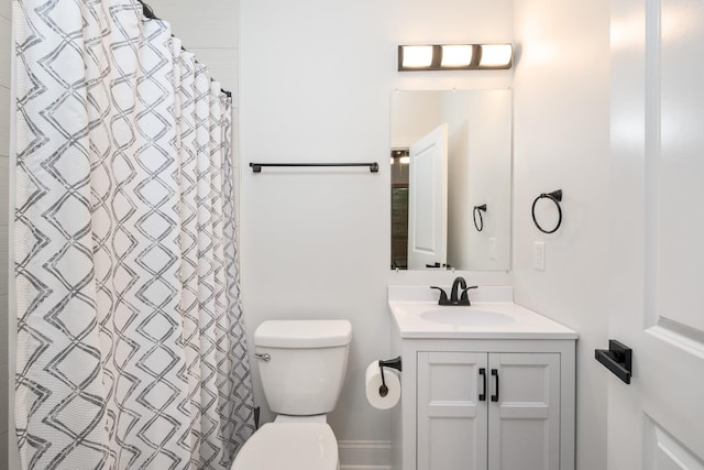 bathroom with vanity, curtained shower, and toilet