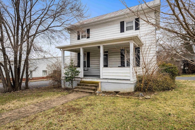 traditional style home featuring a front lawn and a porch