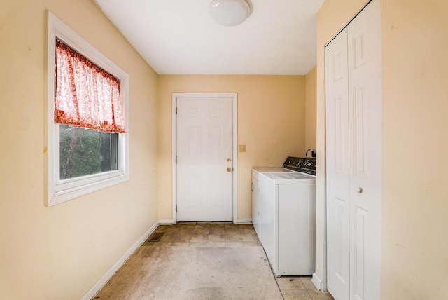 laundry room featuring laundry area, washer and dryer, and baseboards