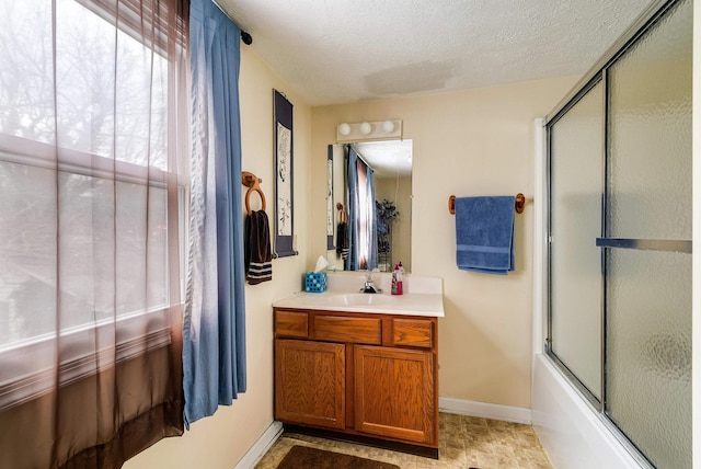 full bath with enclosed tub / shower combo, baseboards, a textured ceiling, and vanity