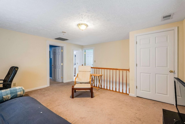 living area featuring baseboards, visible vents, and carpet flooring