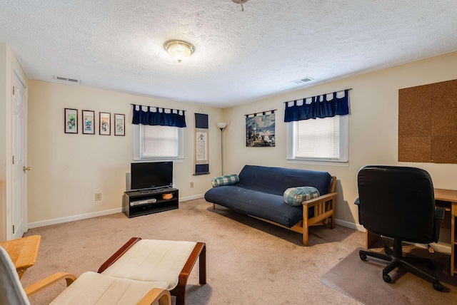 office space with carpet flooring, visible vents, and baseboards