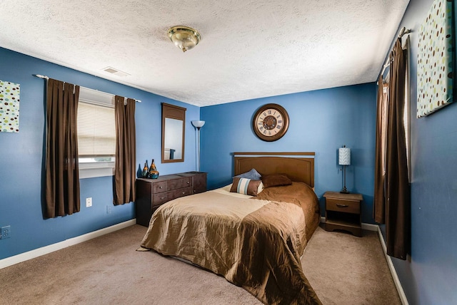 bedroom featuring visible vents, a textured ceiling, baseboards, and carpet flooring