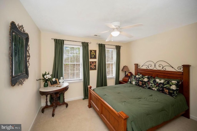 bedroom featuring visible vents, light carpet, baseboards, and ceiling fan