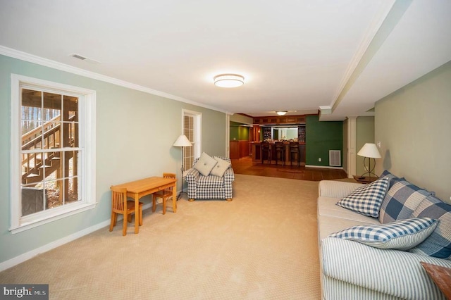living room featuring carpet, visible vents, crown molding, and baseboards