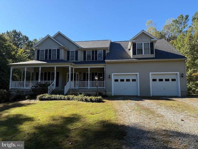 view of front facade featuring a garage, driveway, a front lawn, and covered porch