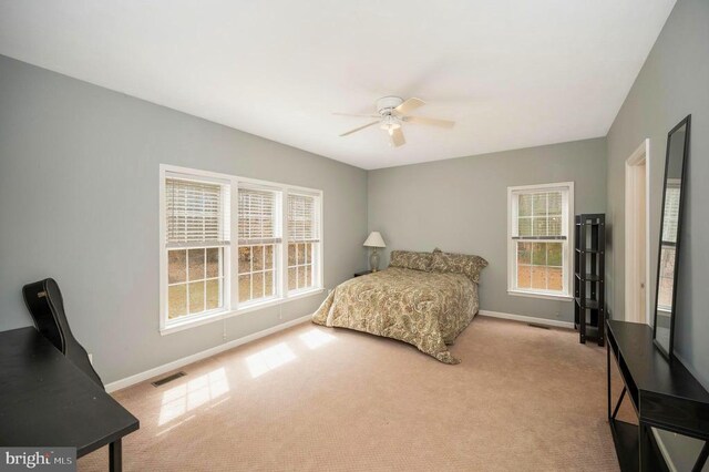 bedroom with ceiling fan, baseboards, visible vents, and carpet