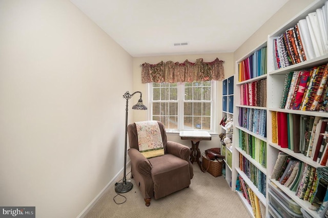 sitting room with carpet, visible vents, and baseboards