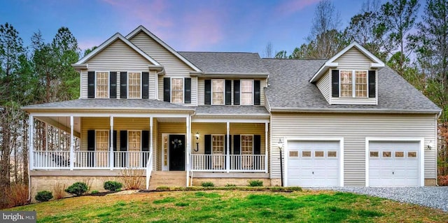 view of front of property with covered porch, a garage, a lawn, a shingled roof, and gravel driveway