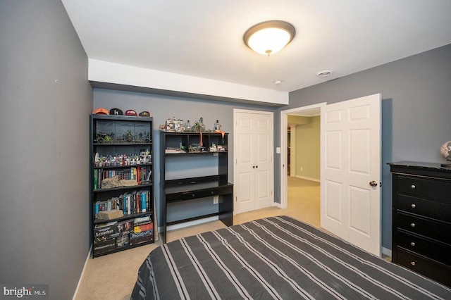 bedroom featuring carpet and baseboards