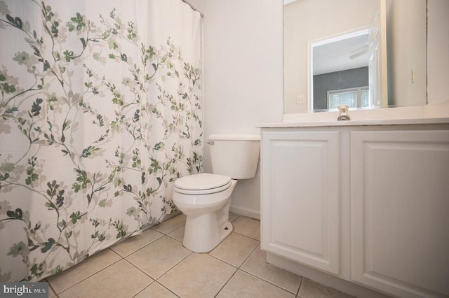 bathroom with a shower with curtain, tile patterned floors, vanity, and toilet