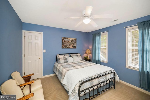 carpeted bedroom featuring visible vents, a ceiling fan, and baseboards
