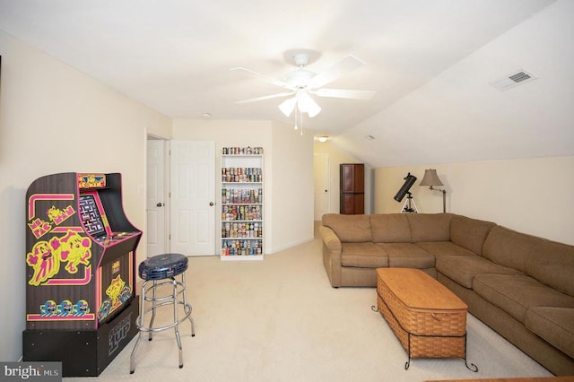 carpeted living room featuring ceiling fan, lofted ceiling, and visible vents
