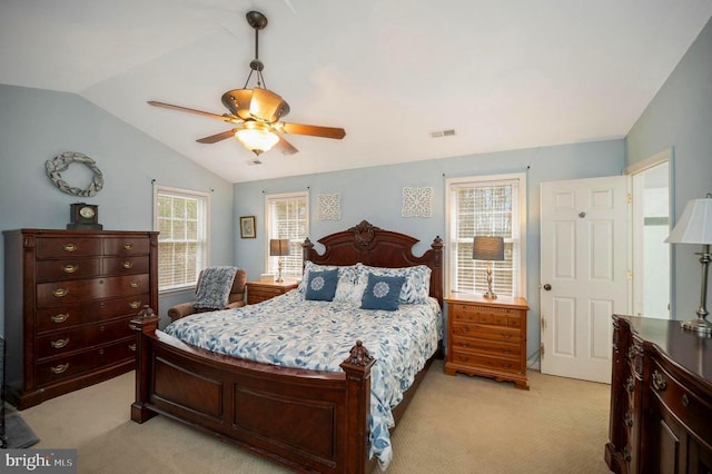 bedroom featuring lofted ceiling, visible vents, ceiling fan, and light carpet