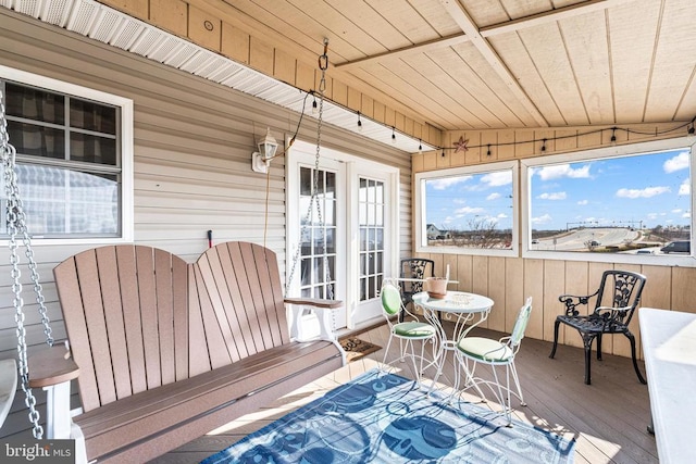 sunroom featuring vaulted ceiling and wooden ceiling