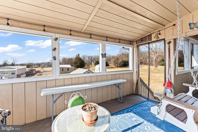 rear view of property featuring a lawn and a sunroom