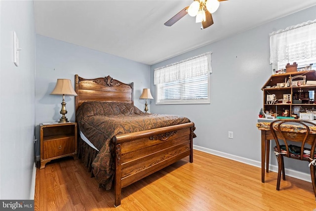 bedroom with ceiling fan and light hardwood / wood-style floors