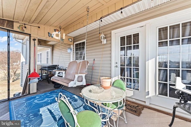 sunroom / solarium featuring wood ceiling