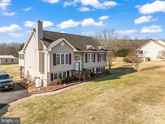 raised ranch featuring a front lawn