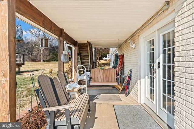 view of yard featuring a pool side deck and a sunroom