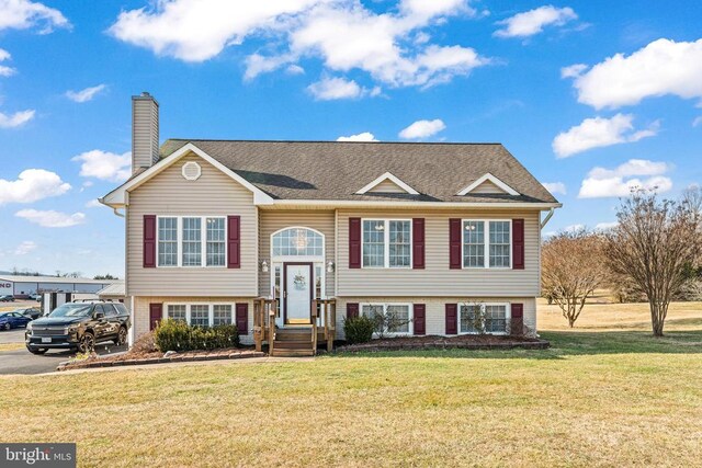 raised ranch featuring a front yard