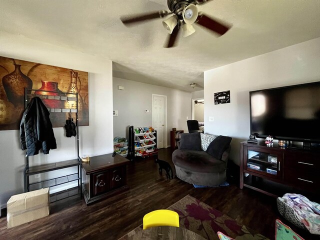 living room featuring dark hardwood / wood-style floors and ceiling fan